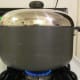 Add sauteed vegetables to browned chicken and water to cook covered in large pot.