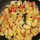 Saute potatoes, onions, and red peppers in same frying pan after chicken.