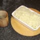 Spreading the potato on the fish pie with a hot knife