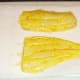 Marinated haddock fillets are patted dry with kitchen paper