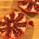 3. Using your thumbs, gently pull of edges pomegranate back. This will loosen the seeds.