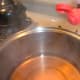Step 2: I add a bit of yellow food coloring to intensify the color. This usually makes a lovely light-orange jelly