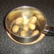 Butter and dill are added to drained new potatoes