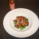 Peri peri sauce is drizzled over salad
