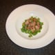 Chopped bacon is scattered on watercress