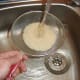 Rice is rinsed in cold water before it is cooked