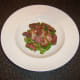 Sliced pigeon breasts are added to the salad