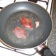 Pigeon breasts are added to frying pan
