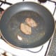 Pigeon breasts are turned halfway through cooking