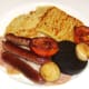 Tomato and mushrooms are added to plate