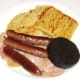 Sausages and black pudding are laid on bacon