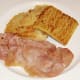 Potato and soda farls are plated with bacon