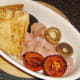 Tomato and mushrooms added to holding dish