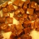 Caramels and evaporated milk in pan.