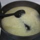 Step 4 (part 1): Add the first part of the liquid to the rice.