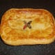 Rabbit and pork pie is removed from the oven and rested