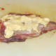 Rubbing butter on rabbit saddle