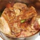 Rabbit and pork is re-added to pot with vegetables