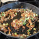 cooking the mushrooms and onions in olive oil