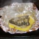 Baked flounder is carefully unwrapped