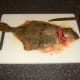 The head is cut from the flounder and removed