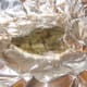 Scored flounder is laid on the butter