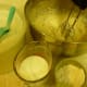 Measuring out and adding ingredients to the mixing bowl for spice cake recipe.