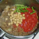 Tomatoes, beans and chickpeas are added to curried mince