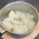 Drained potatoes are left to steam