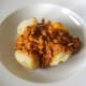 Mince and beans are carefully spooned in to centre of baked potato