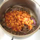 Baked beans are added to mince and onions