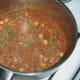 Curried mince is brought to a simmer
