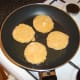 Starting to shallow fry the garlic and chive potato cakes