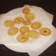 Potato discs are drained on kitchen paper