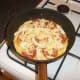 Grated cheese is scattered over the tortilla