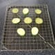 Courgette and aubergine slices are drained and rested on a wire rack