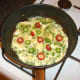 Chilli peppers are added to mostly set egg