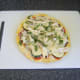 Basil garnishes pizza omelette for service