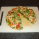 Tex mex chicken pizza omelette is garnished halved for service