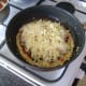 Cheese is scattered over pizza omelette last of all