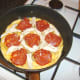 Chorizo and chicken are laid on top of the tortilla