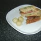 Steak, smoked salmon and horseradish sandwich is served with pickled onions