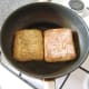 Toasting honey and sunflower seed roll in extra virgin olive oil