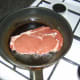 Starting to fry the rib eye steak