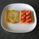 Sliced strawberries are added to smoked salmon