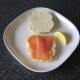 Lemon juice ready to be squeezed on smoked salmon