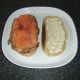 Smoked salmon slices are laid over steak