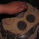 With a biscuit cutter or the top of a cup, cut your biscuits from the dough. When you run out of dough to cut, form all the scraps into a new ball and roll it out again. Repeat until you've only got enough left for one biscuit—shape that by hand.