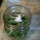 Adding salt to the pint jars. 1/2 teaspoon for pints, 1 teaspoon for quarts.