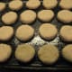 Place biscuits on a greased dark pan.